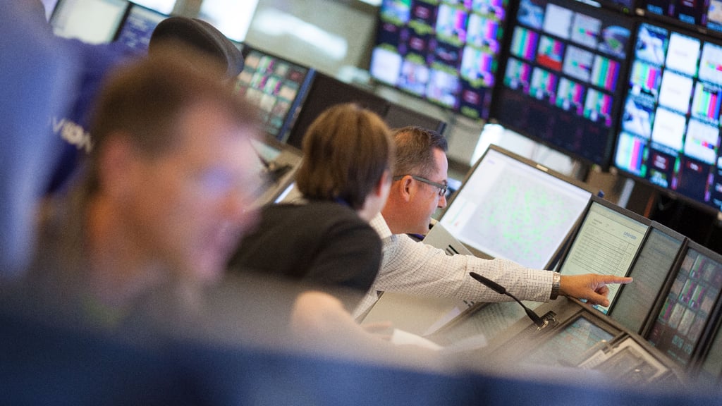 Three journalists work in a newsroom