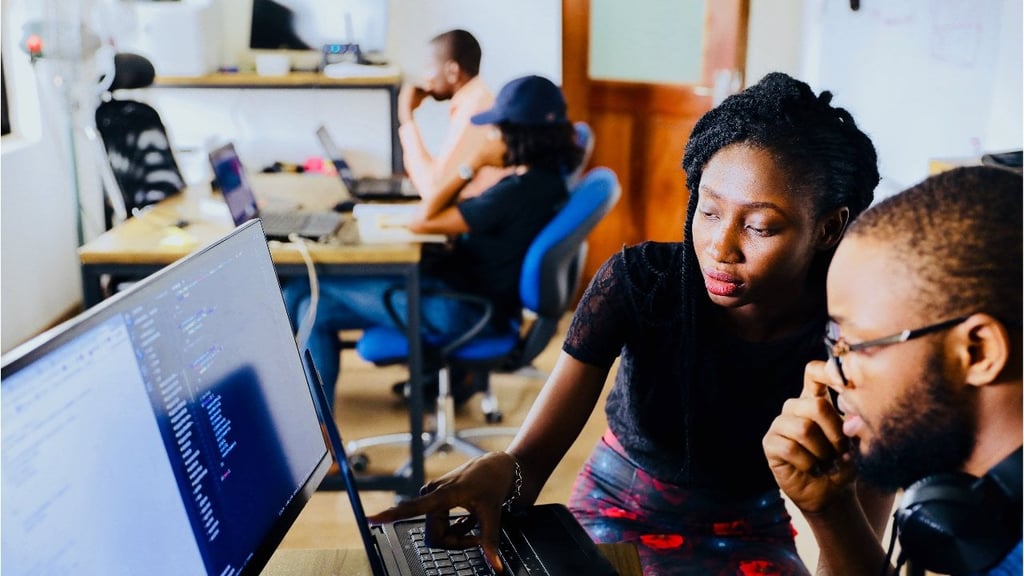 Two young people look at a screen