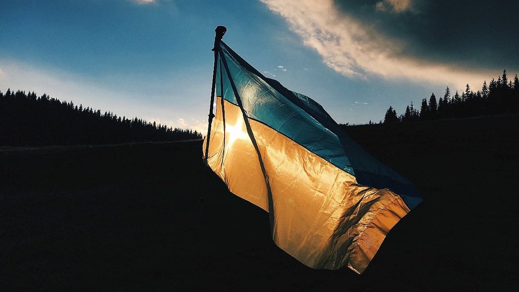 Image of the Ukrainian flag against a dark moody background